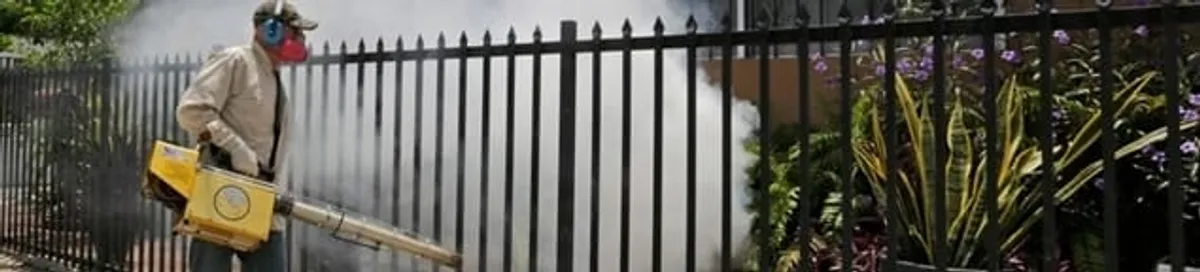 Mosquito control technician fogging a yard perimeter for mosquito reduction in Salt Lake City, UT